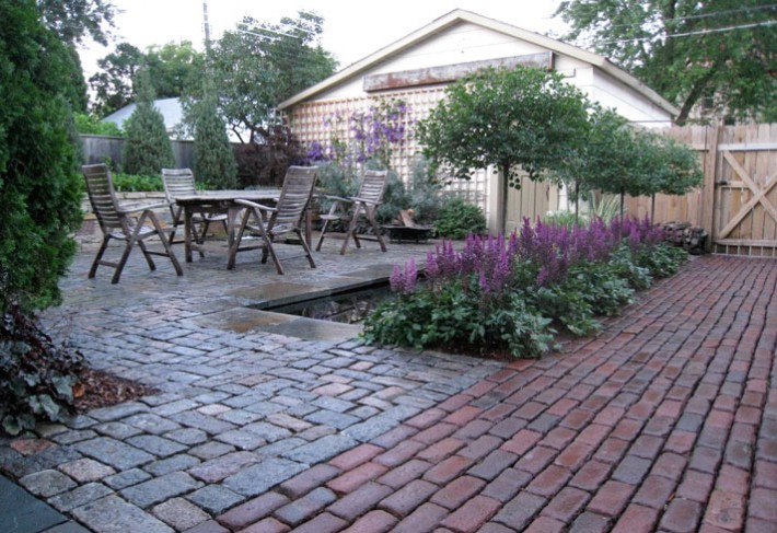 grafted lilac trees as focal point of reclaimed paver patio